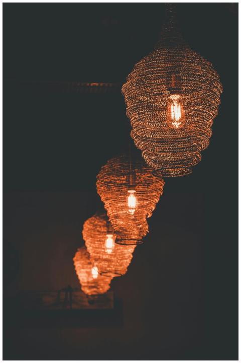 Stylish spiral lamps illuminate a dim room with wa