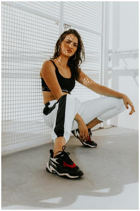 Confident woman in urban attire, featuring trendy