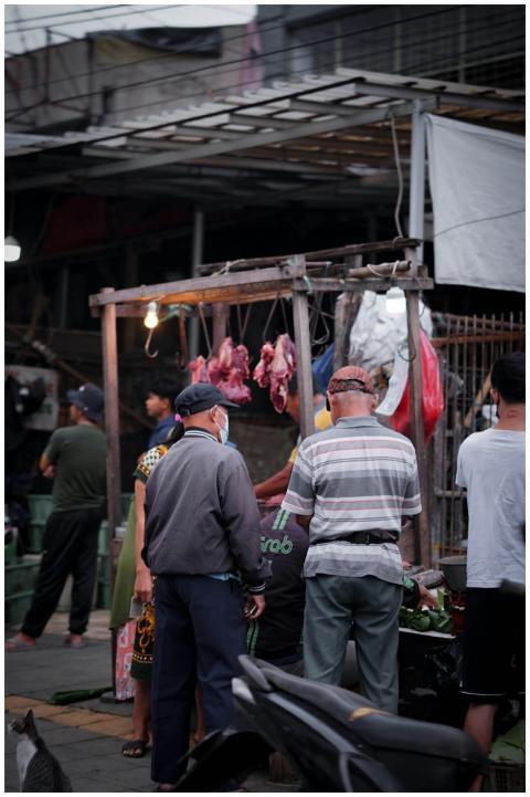 Street vendors and shoppers at a vibrant market in