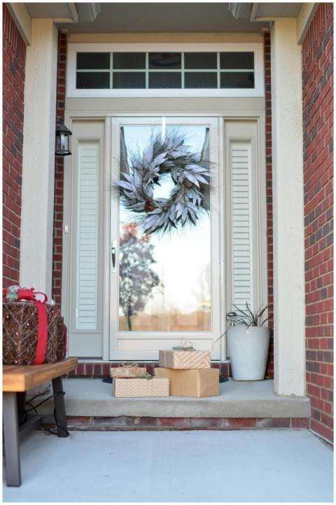 An inviting front door adorned with a holiday wrea