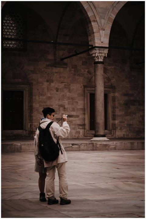 Tourists capturing a moment within a historic arch