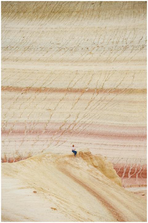 Person exploring the unique rock formations in the