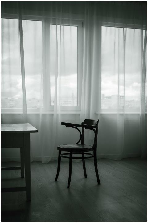 A stylish minimalist room featuring a wooden chair