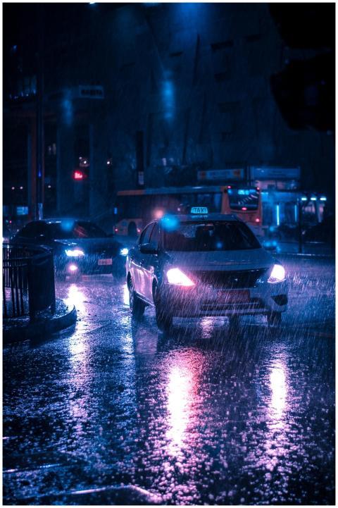 Urban street at night with cars in heavy rain, ref