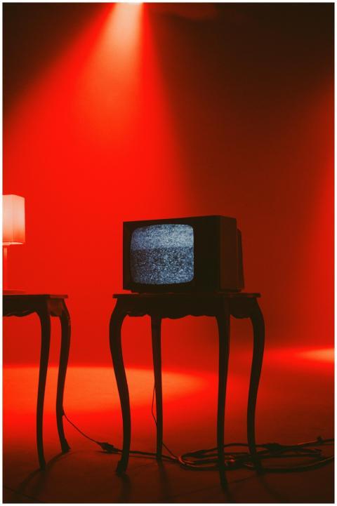 Retro TV displaying static on wooden table under d