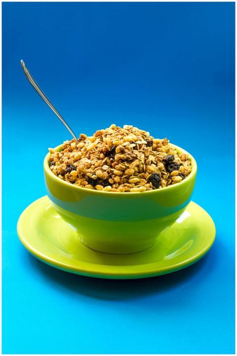 Bright and healthy granola in a colorful bowl, per