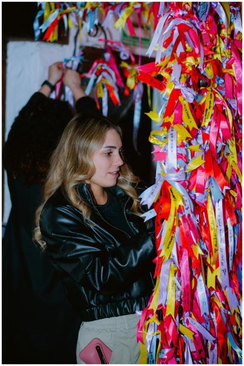 Woman Tying Colorful Ribbons