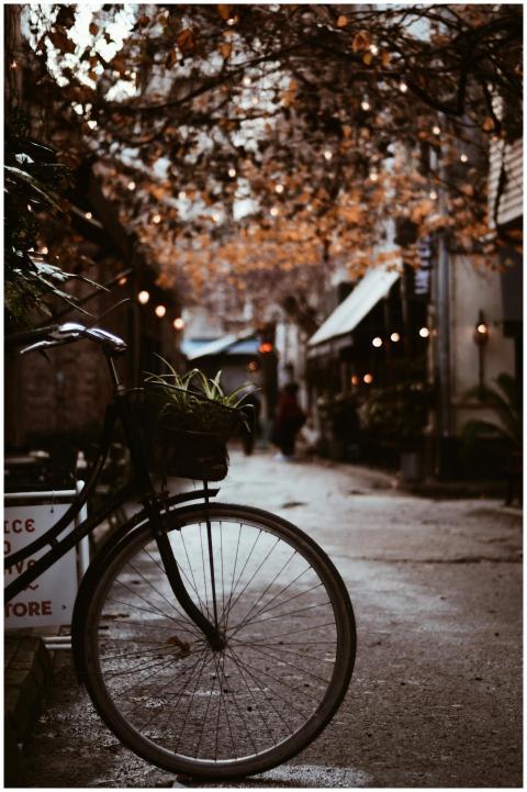 A vintage bicycle parked on a dimly lit urban stre