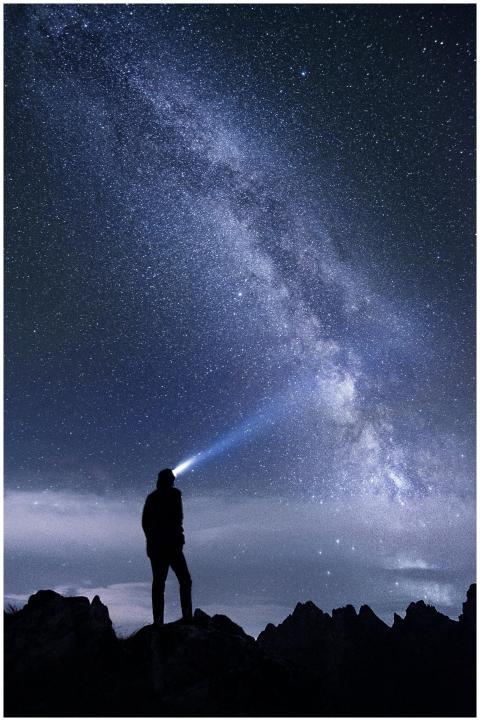 Silhouette of a person exploring the star-studded