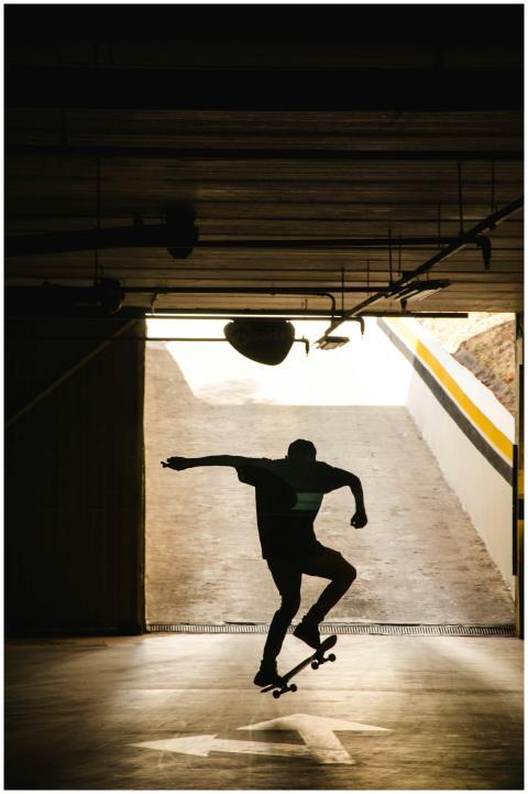 Silhouette of a skateboarder performing a trick in