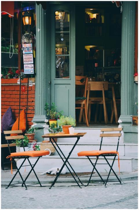 Cozy outdoor café with colorful chairs and rustic