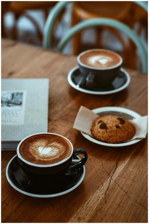 Cozy cafe setup with cappuccinos and a chocolate c