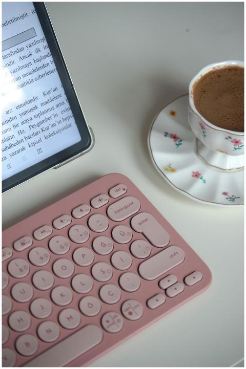 A stylish home workspace featuring a pink keyboard