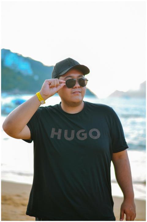 Man in black shirt and cap enjoying a sunny day at