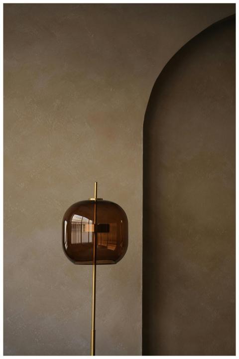 A sleek modern floor lamp standing against a minim