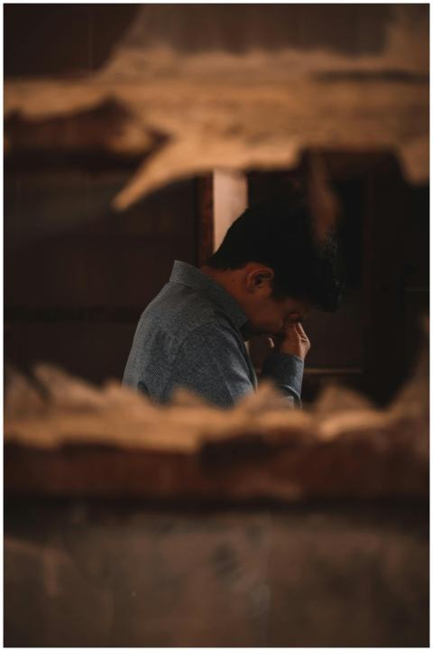 A man in deep thought captured indoors through a b