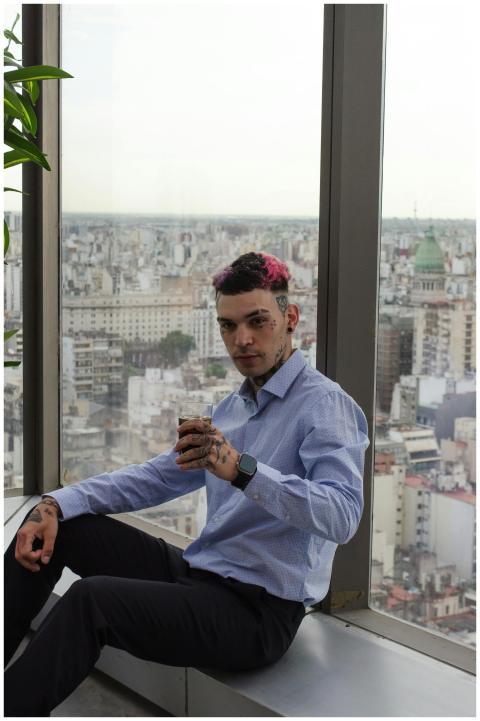 Businessman with tattoos enjoys a break in a moder