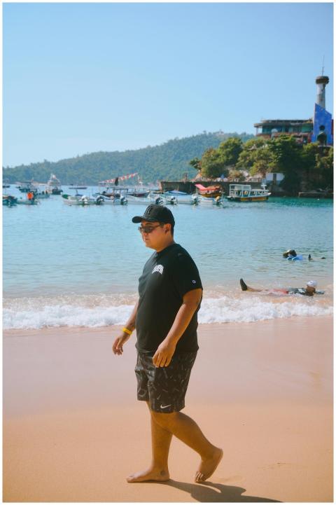 Adult male strolling by the ocean with scenic back