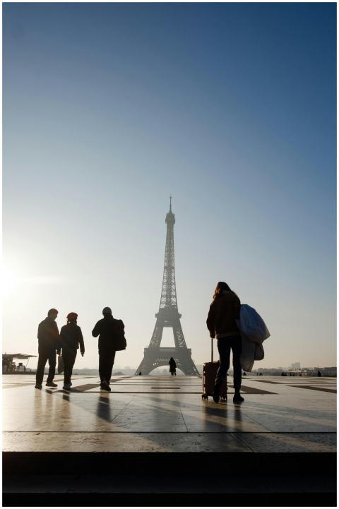 Silhouette of people walking near Eiffel Tower at