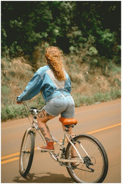 Woman riding a bicycle outdoors, showcasing casual