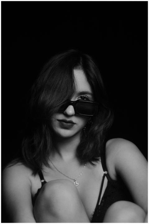 Stylish black and white portrait of a woman in sun