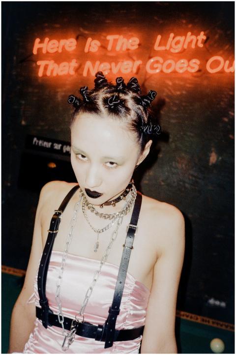 A striking portrait of a woman in edgy fashion wit