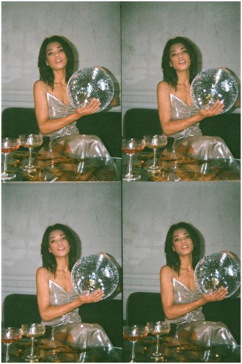 Stylish woman in silver dress posing with a disco