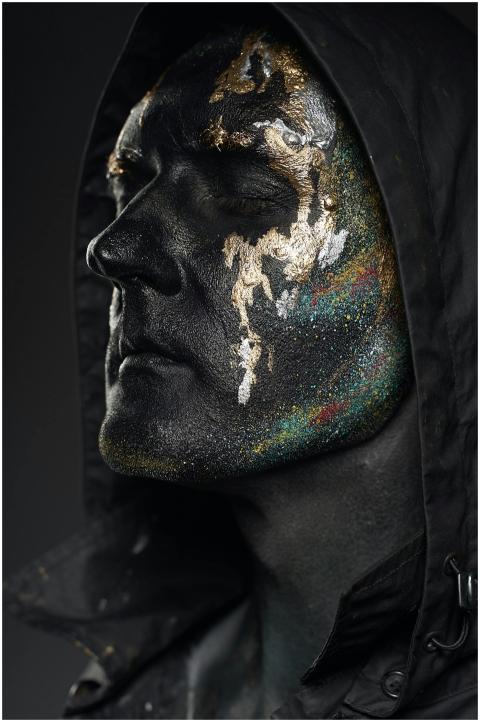 Close-up artistic portrait of an adult with black