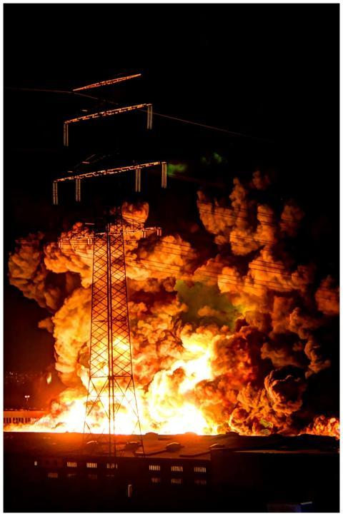 A powerful nighttime explosion at a factory with f