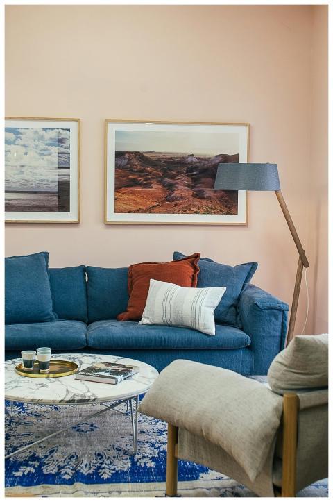 Contemporary living room with blue sofa, artwork,