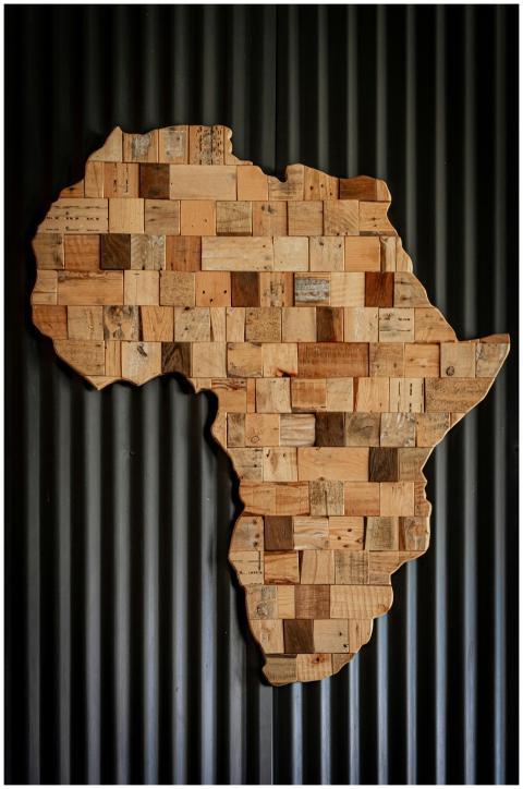 Artistic wooden map of Africa against dark corruga