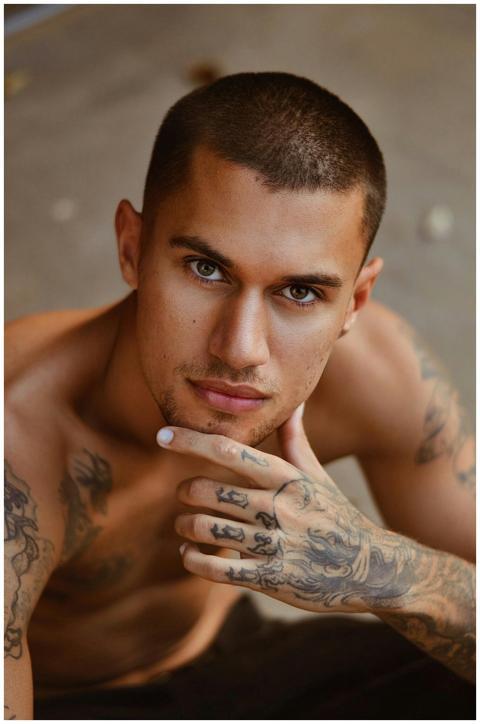 Close-up portrait of a tattooed man posing shirtle