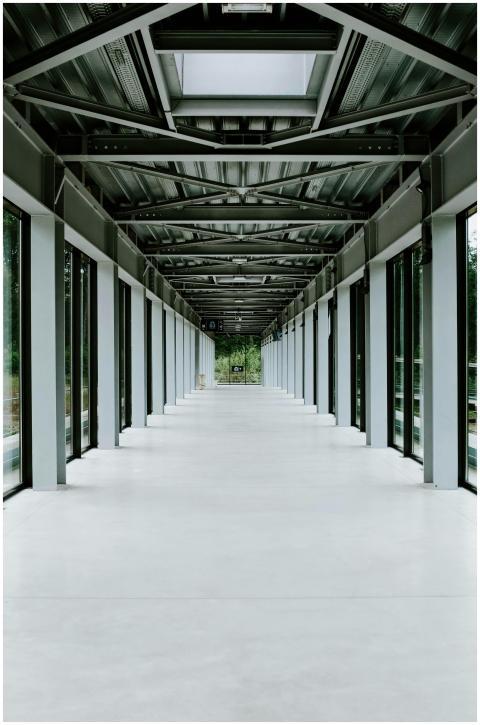 Empty modern glass corridor with metal framework a