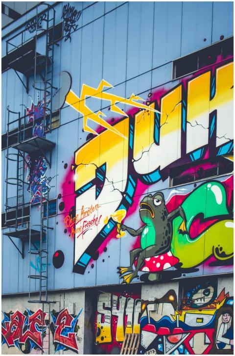 Colorful graffiti mural featuring bold text and fr