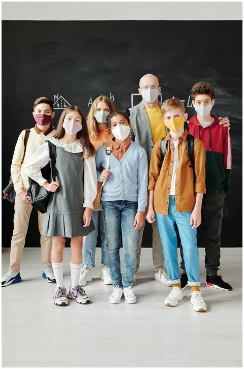 Group of students and teacher wearing face masks i