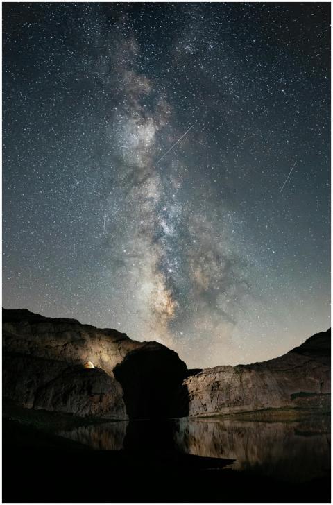 Starry night sky with the Milky Way over rocks in