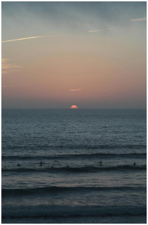 Serene Sunset Surfers Ocean