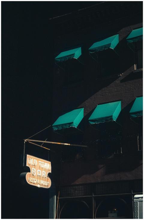 Moody night scene of Old Town Bar with neon sign a