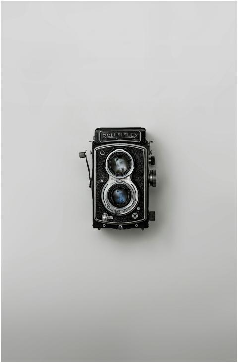 Classic Rolleiflex camera showcased against a simp