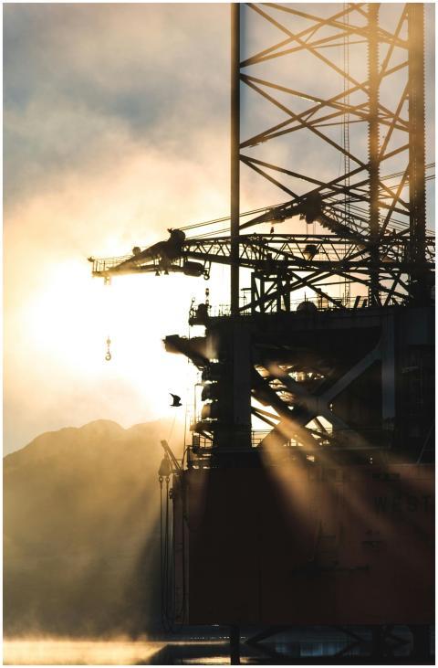 Dramatic silhouette of industrial machinery agains