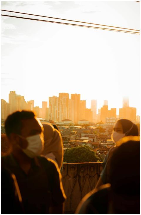 A vibrant urban sunset with masked individuals in
