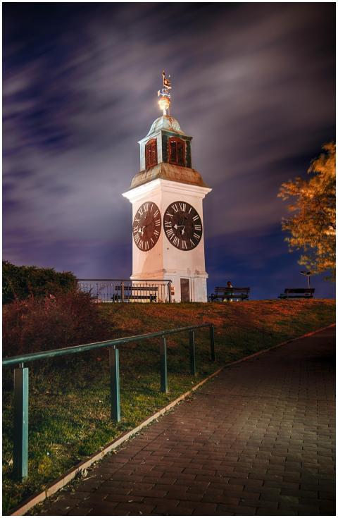 The illuminated Petrovaradin Clock Tower shines ag