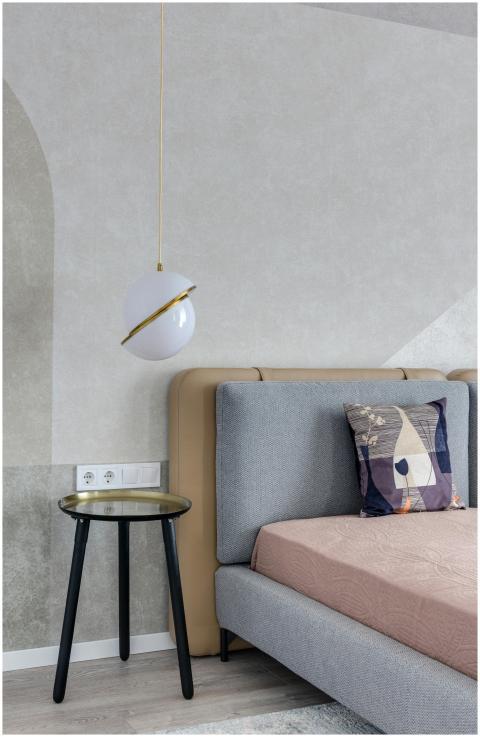 Comfortable bed with colorful pillow near bedside