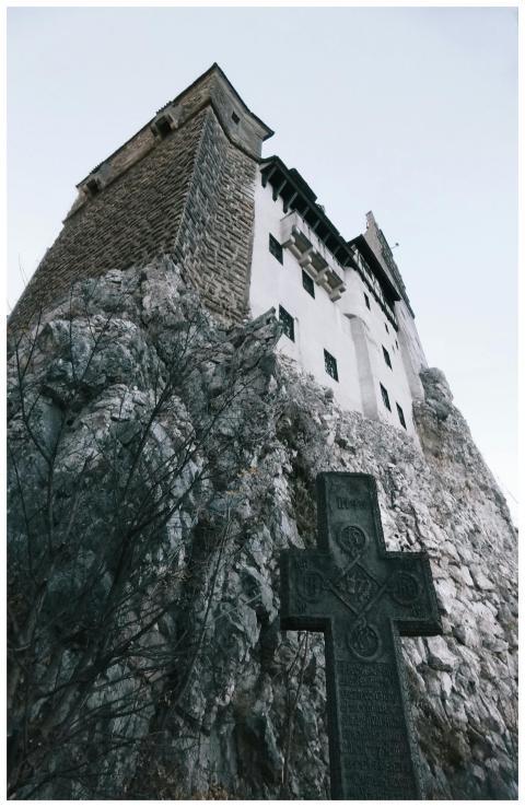 A dramatic view of a medieval castle on a rocky cl