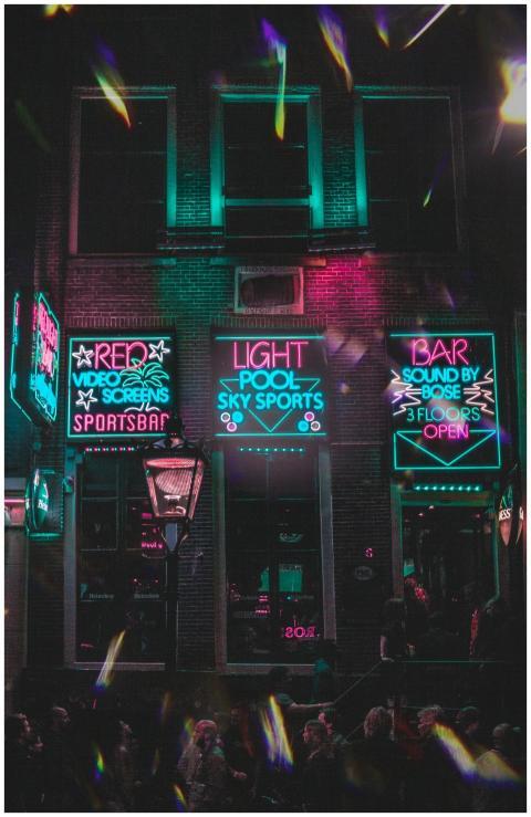 Dynamic neon-lit bar facade in Amsterdam's vibrant