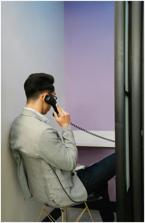 Back view of a businessman in a modern office talk