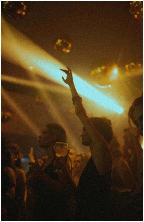 Vibrant nightclub scene with people dancing under