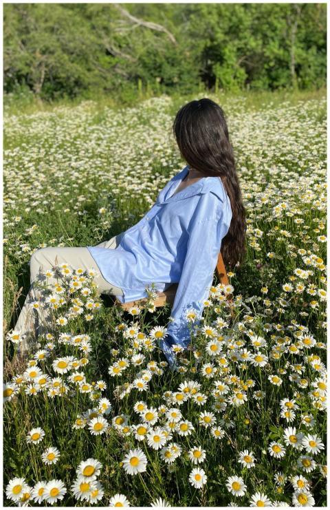 A serene outdoor scene of a woman sitting in a lus
