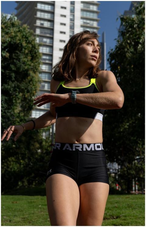 Young woman in sportswear jogging in a sunny city