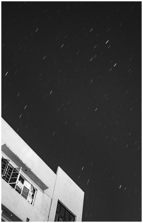 Black and white from below long exposure of stars